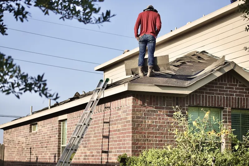 Professional roofer working on a residential roof in Calhoun
